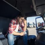 truck-driver-sitting-his-truck-cabin-feeling-worried-upset